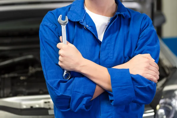 Mechanic holding wrench with crossed arms