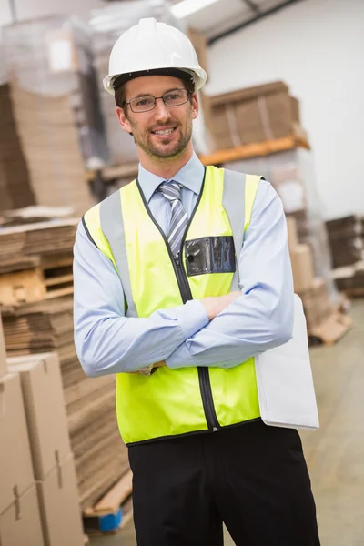 Worker wearing hard hat in warehouse