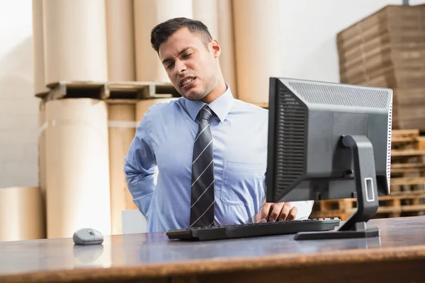 Warehouse manager working on computer