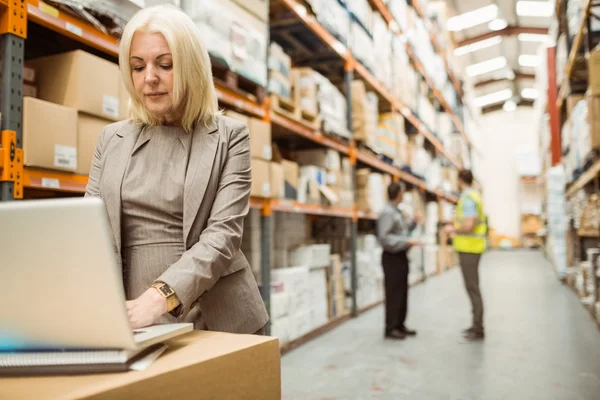 Focused warehouse manager working