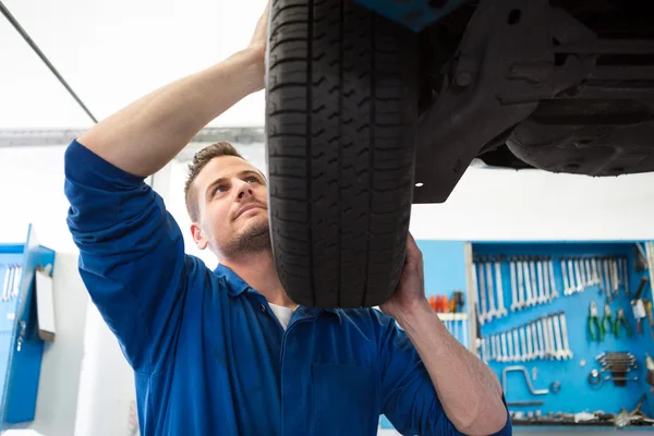 Mechanic adjusting the tire wheel