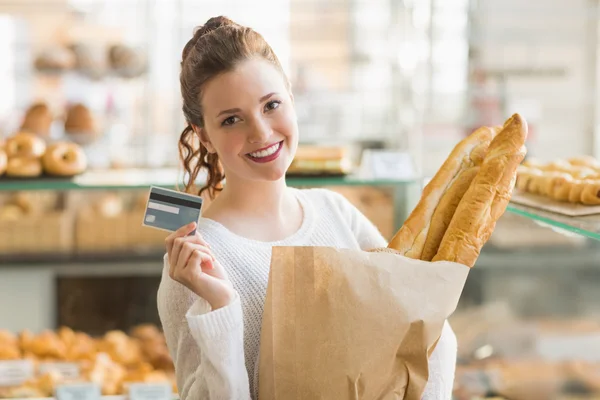 Brunette with bag of bread and credit card