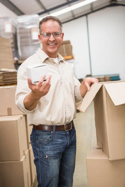Warehouse worker holding small box