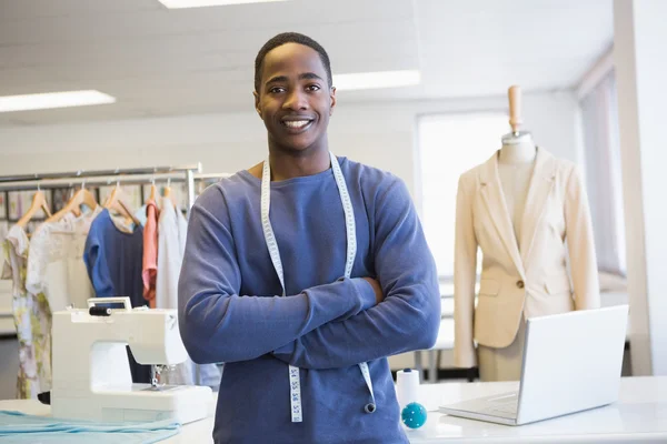 Smiling university student posing with arms crossed