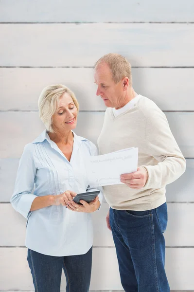 Mature couple working out their bills