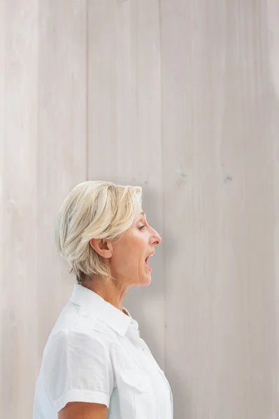 Composite image of happy mature woman talking loudly