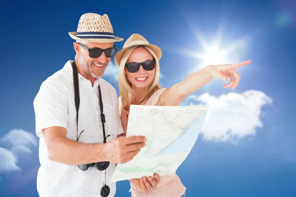 Tourist couple using map and pointing