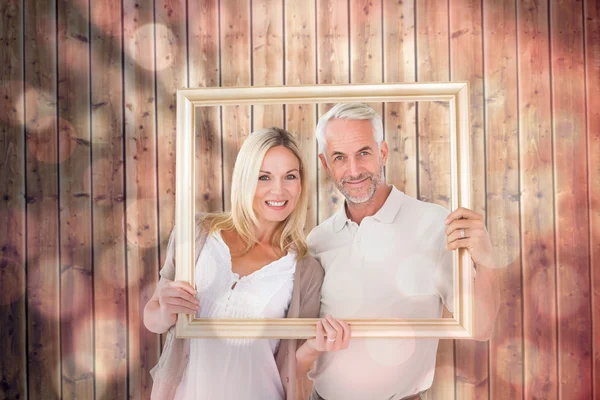 Happy couple holding a picture frame