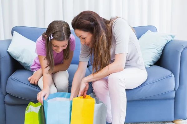 Mother and daughter looking at shopping bags