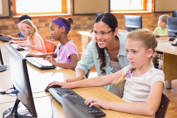 Cute pupils in computer class with teacher