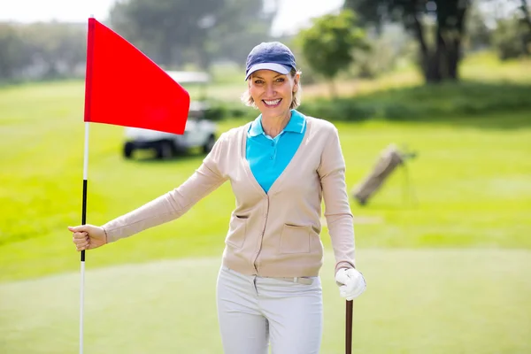 Female golfer holding her golf club