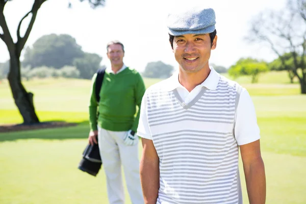 Golfing friends smiling at camera