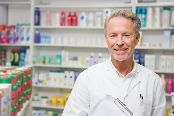 Senior pharmacist holding a clipboard