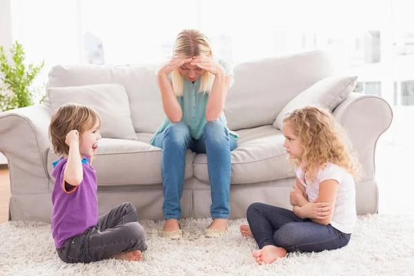 Upset woman while brother teasing sister