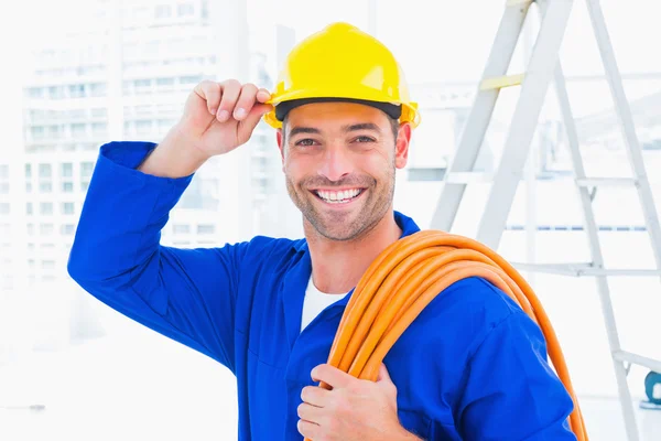 Confident repairman wearing hard hat