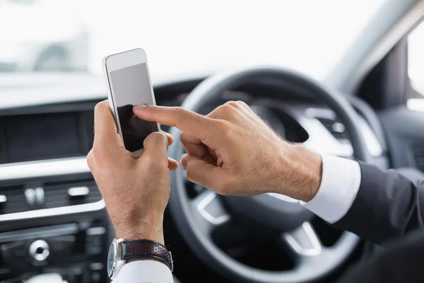 Businessman sending text message