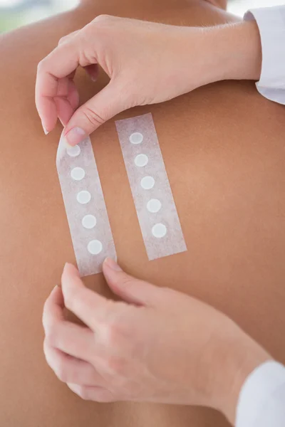 Doctor doing skin test to her patient