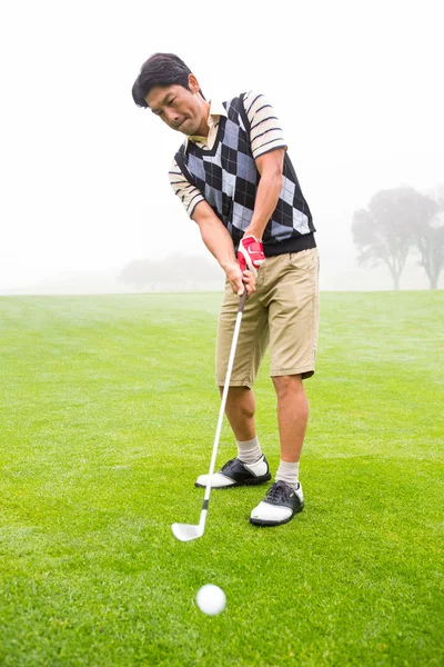 Golfer teeing off