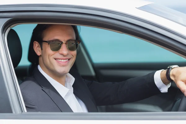 Happy businessman in drivers seat