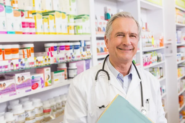 Smiling doctor with stethoscope holding notebooks