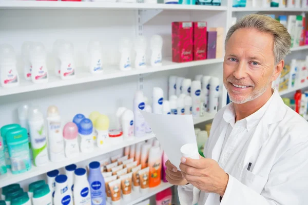 Senior pharmacist holding a prescription