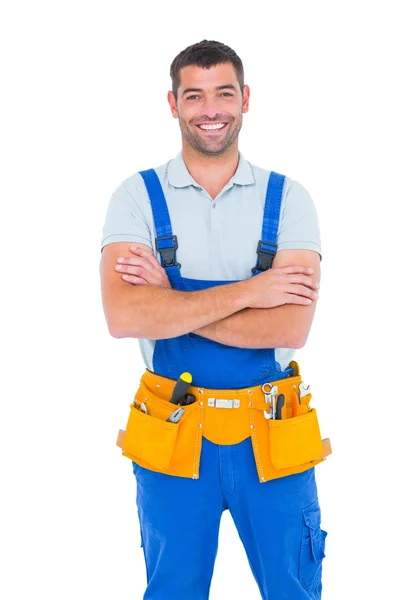 Repairman in overalls standing arms crossed