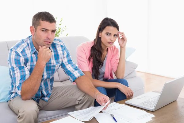Couple calculating home finances together in house