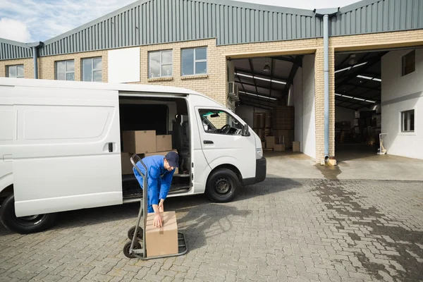 Delivery driver packing his van