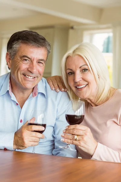 Happy mature couple drinking red wine