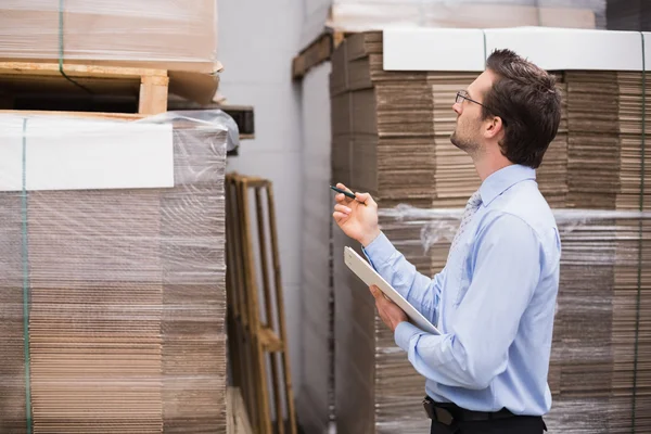 Warehouse manager checking his inventory