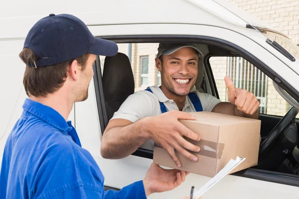 Delivery driver handing parcel to customer