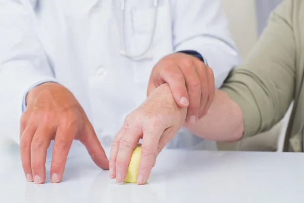 Doctor assisting female patient