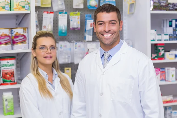 Team of pharmacists smiling at camera