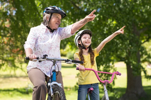 Grandmother with granddaughter on their bike