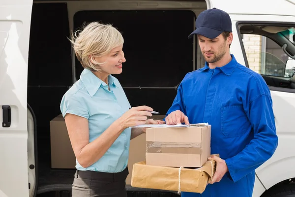 Delivery driver showing where to sign