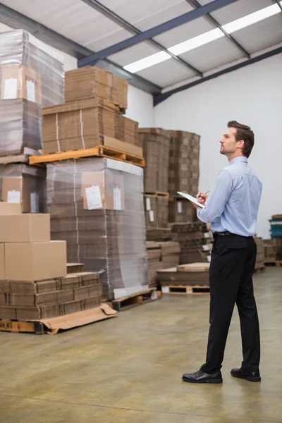 Warehouse manager checking his inventory