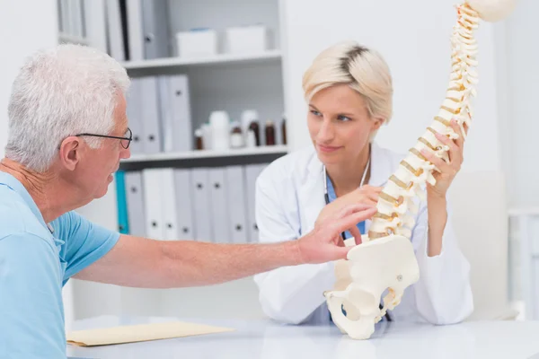 Patient showing spine problems to doctor