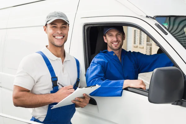 Delivery man getting signature from customer