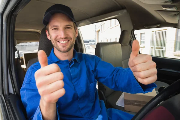 Delivery driver smiling in his van