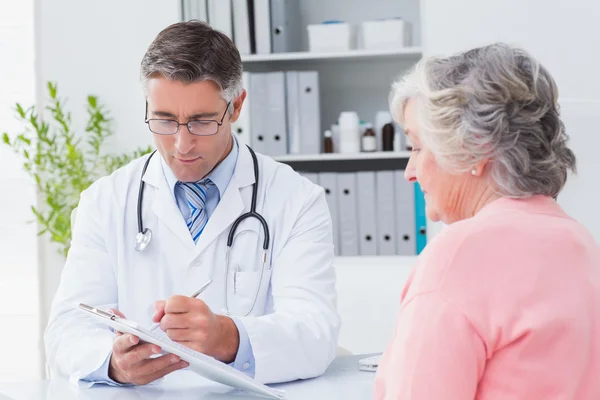 Doctor explaining prescriptions to woman