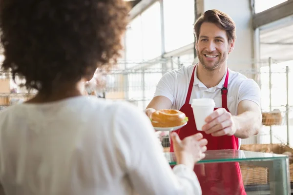 Waiter giving lunch and drink to customer