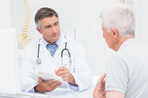 Senior patient sharing problems with doctor