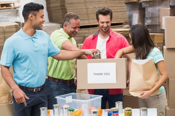 Warehouse workers packing up donation boxes