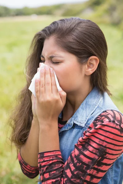 Pretty brunette blowing her nose