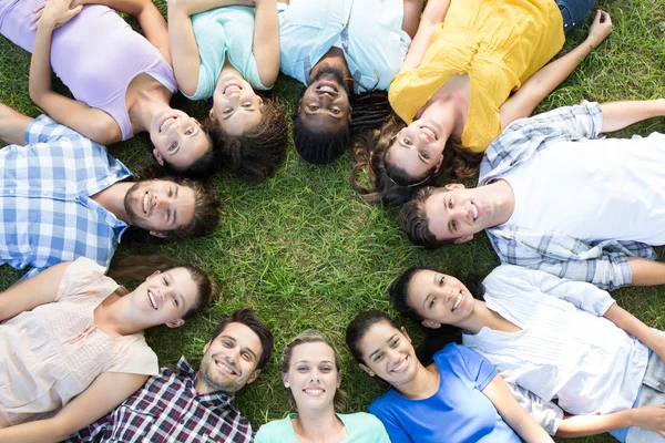 Happy friends in the park lying in circle