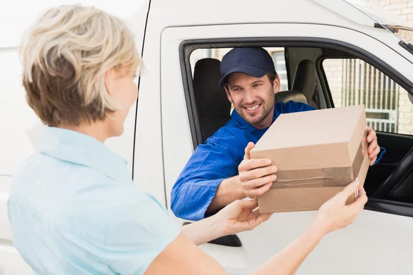 Delivery driver handing parcel to customer