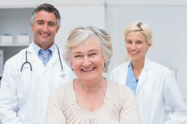 Senior patient smiling with doctors