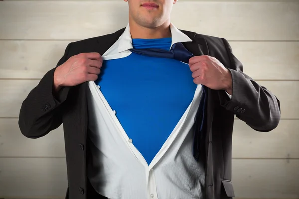 Businessman opening shirt superhero style