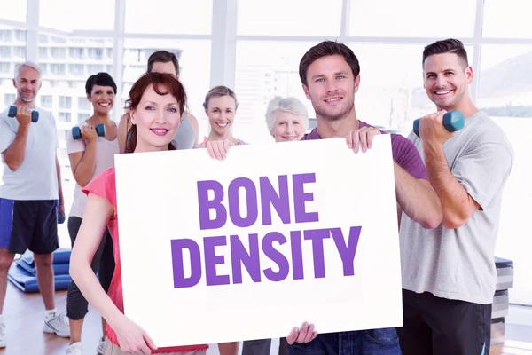 Couple holding sign against bone density