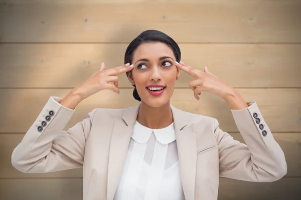 Businesswoman pointing her head with fingers